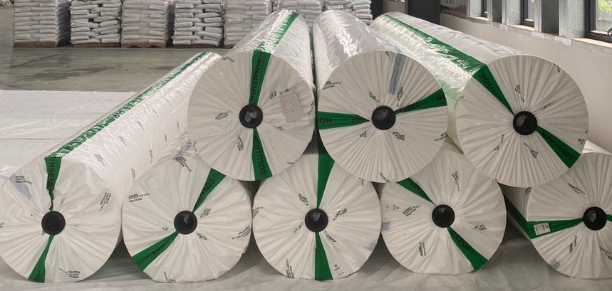 Wrapped PET geotextile rolls stacked in the Jinseed warehouse