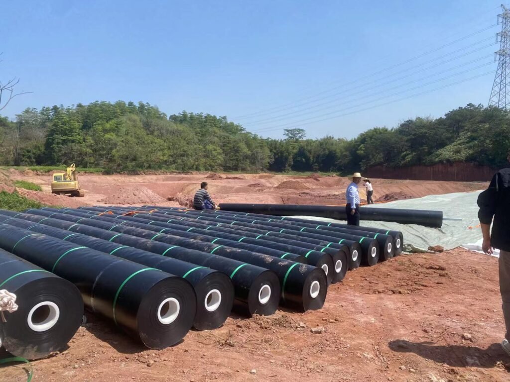 Jinseed HDPE geomembrane rolls staged for installation at a project site
