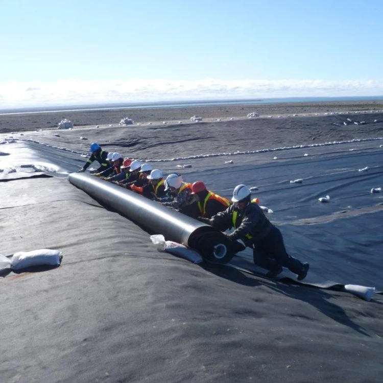 Installation crew unrolling geomembrane at a project site