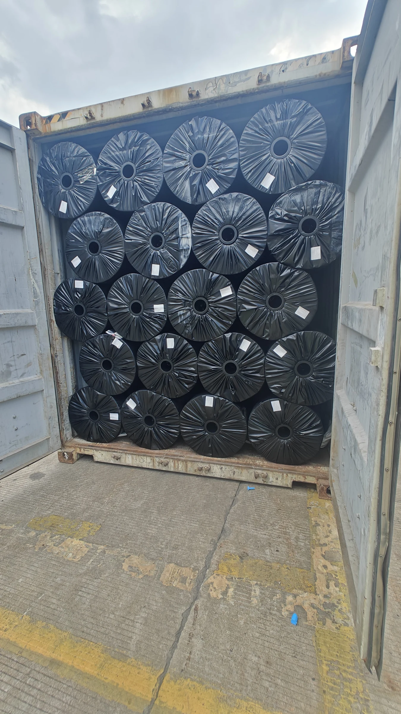 Wrapped geotextile rolls loaded in a shipping container