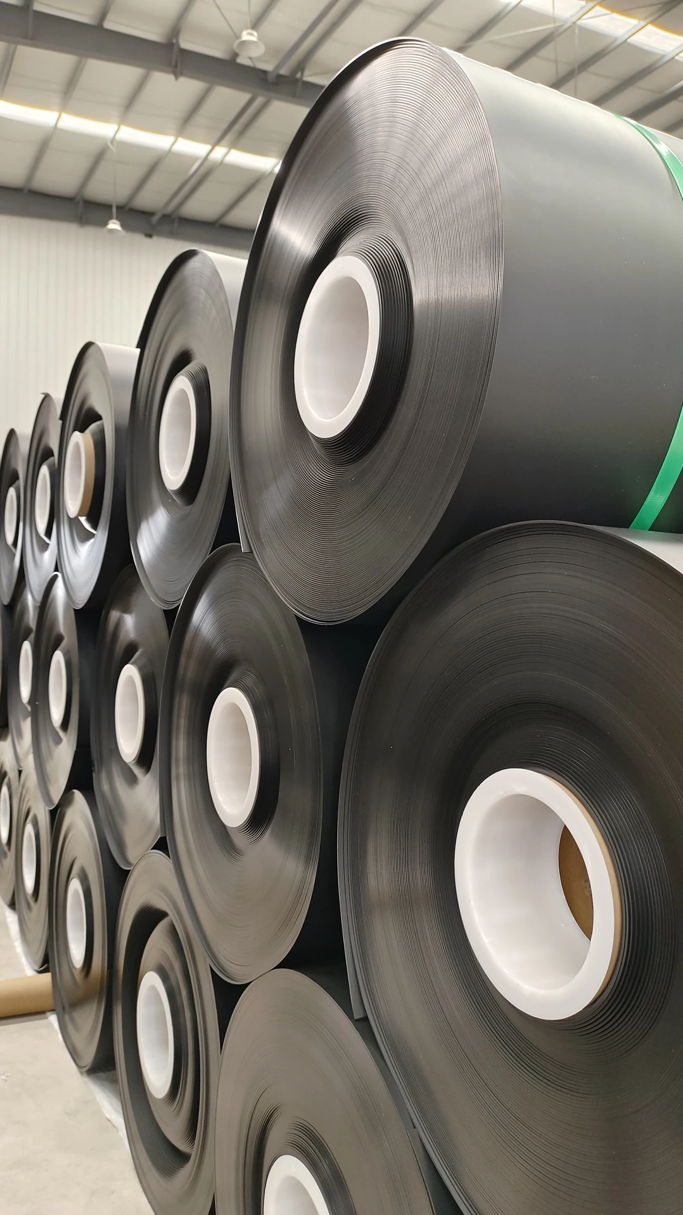 Jinseed smooth HDPE geomembrane rolls in factory storage