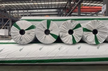 Jinseed-branded wrapped geotextile rolls viewed from the roll ends in the factory