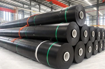Black geomembrane rolls stacked and strapped inside the factory
